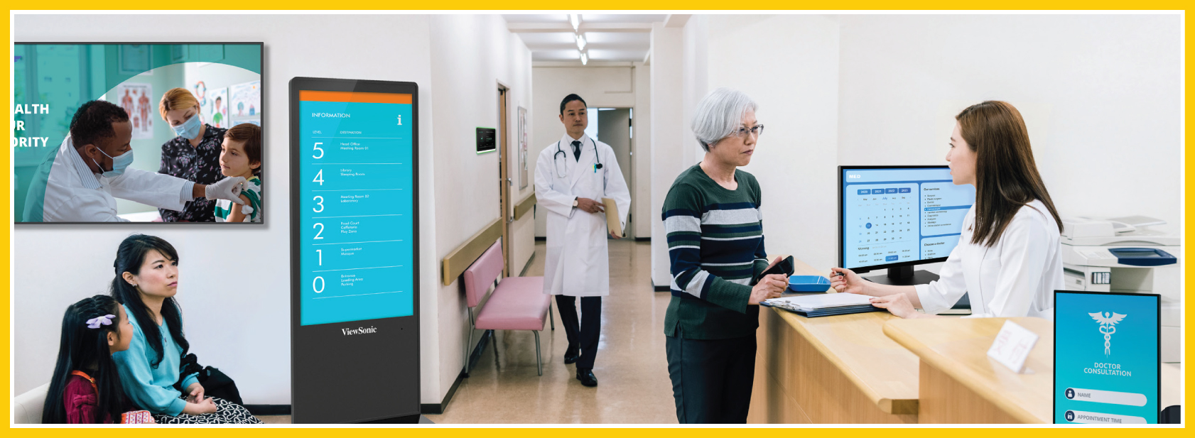 AV: A video screen is on the wall in the background, with a couple of interactive kiosks present in the foreground of a smaller clinic waiting area