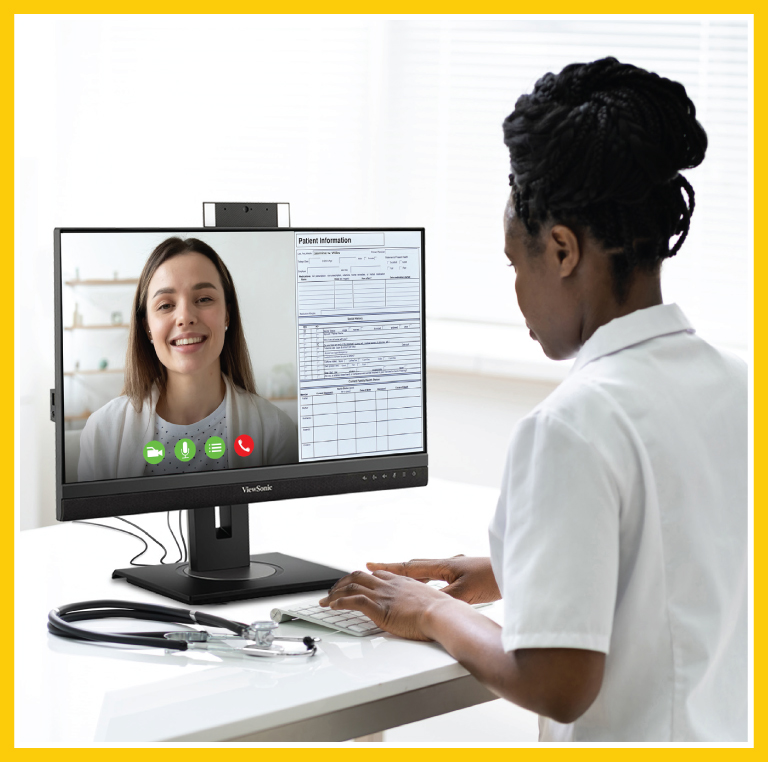 A doctor is on a telehealth visit with a patient. The viewer is seeing this from the doctor's side, with the patient on the computer screen