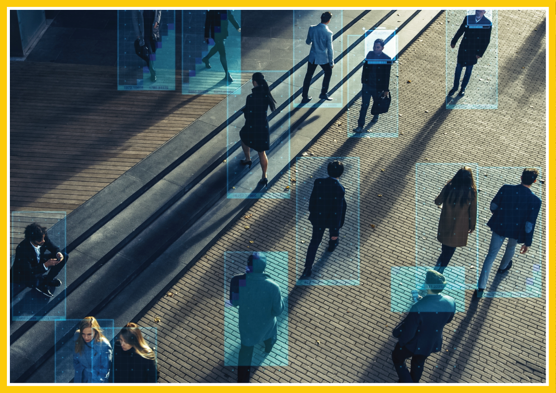Security camera footage scan on a crowd of people walking in front of an office building or courtyard