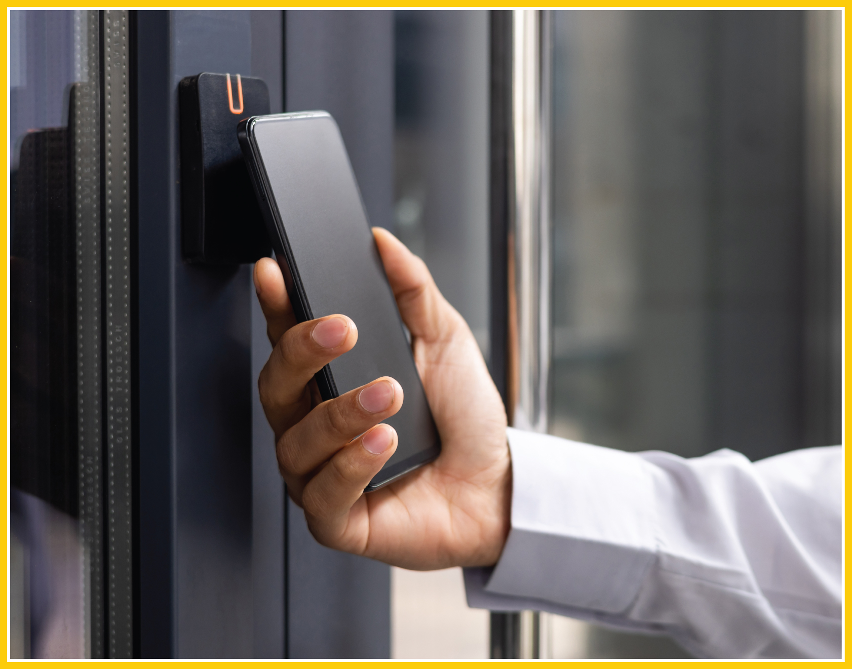 Closeup of a person using their phone as a key for an access control panel