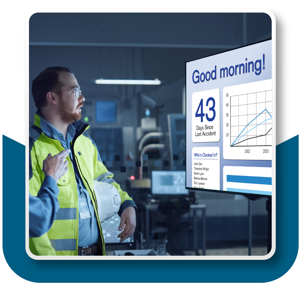 Framed Image: Factory worker reading over an informational display board.
